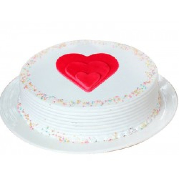 vanilla cake with red heart shape design on top